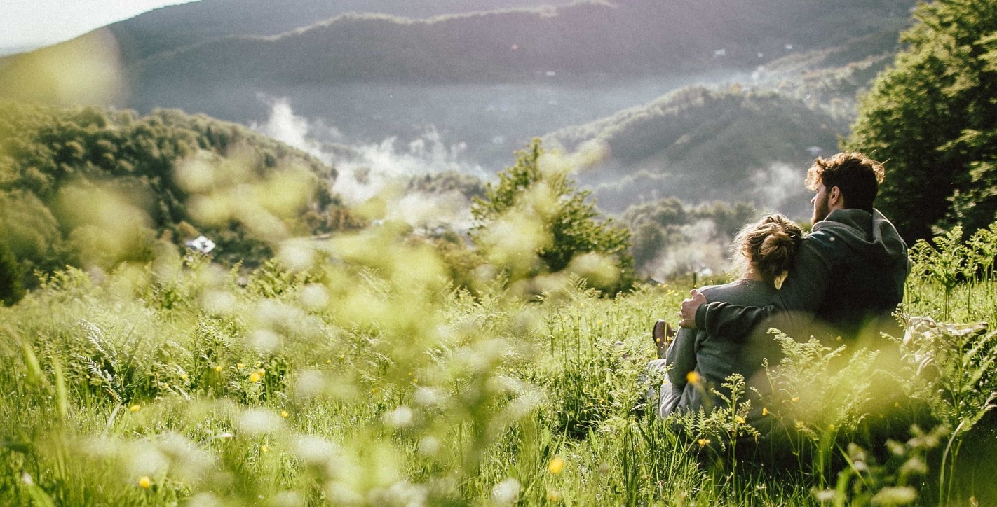 Portrait of young happy caucasian couple enjoying countryside together.